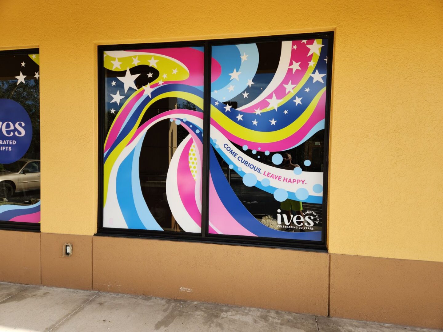 Storefront window with colorful swirls and stars
