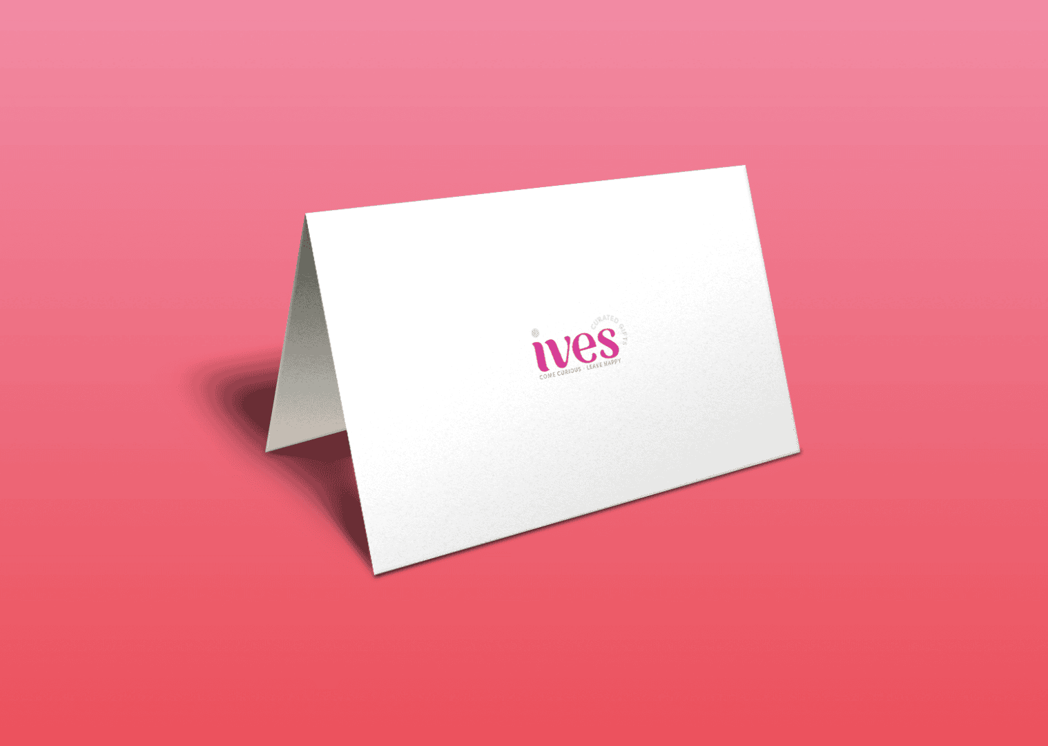 Folded white tent card with pink ives logo