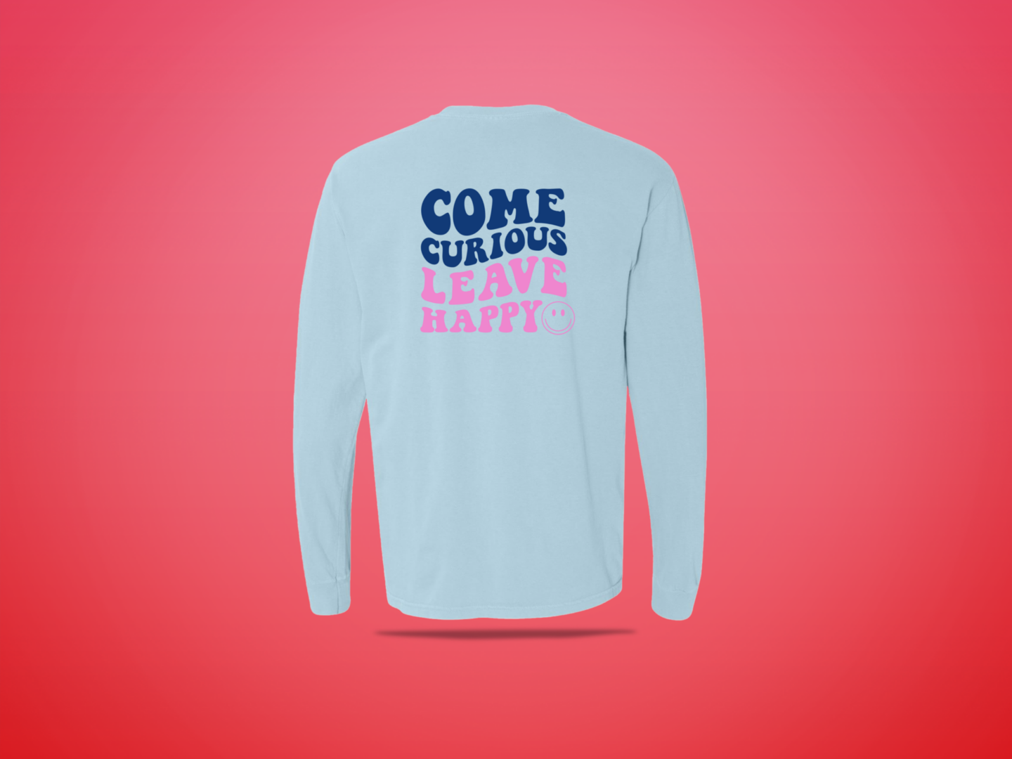 Light blue shirt reading "Come Curious Leave Happy